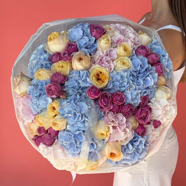 Bouquet of blue and blush hydrangeas, magenta and yellow roses Blue Moon Romance L
