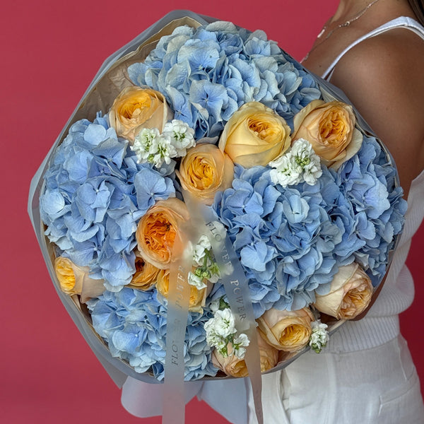 Bouquet of blue hydrangeas and peach garden roses Blue Sunset