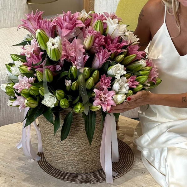 Basket of soft pink and ivory lilies Satin Bloom