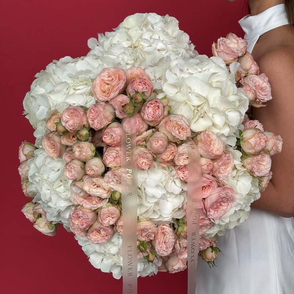 Bouquet of white hydrangeas and pale blush garden spray roses Ivory Bloom